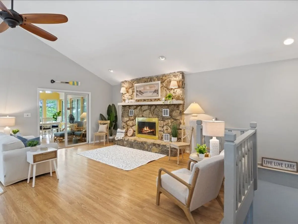 A warm seating area centered around a stone fireplace, with plush chairs and decorative elements. It feels private yet communal—ideal for intimate gatherings or peaceful moments by the fire.